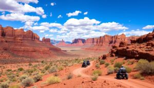 Vibrant landscape of Arizona with rugged red rock formations, a winding dirt trail, and a group of ATVs navigating through the desert terrain under a bright blue sky with scattered clouds.