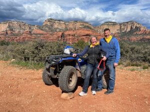 A couple standing in front of a Sedona mountain landscape