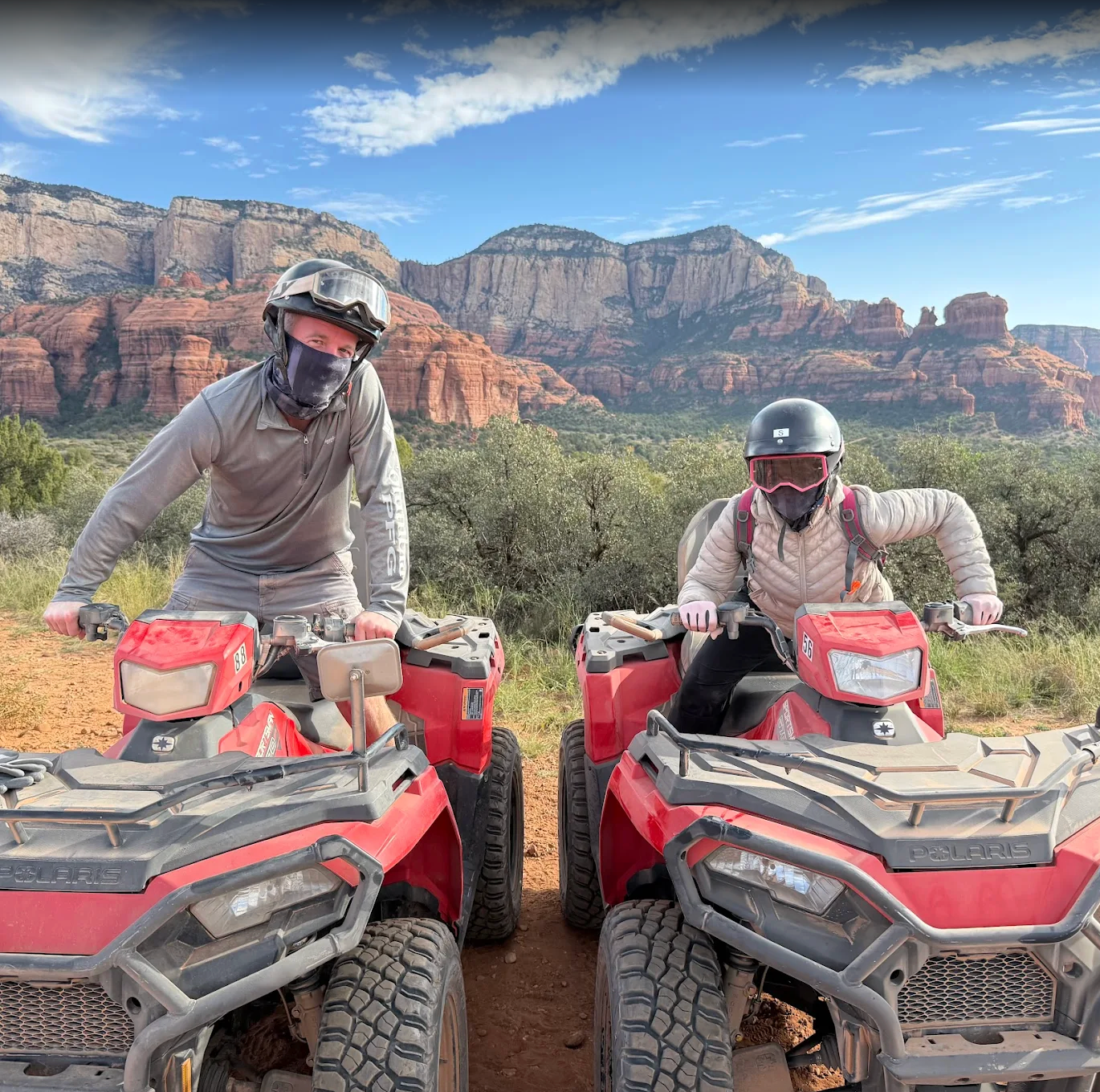 ATV's and their riders with a red rock background