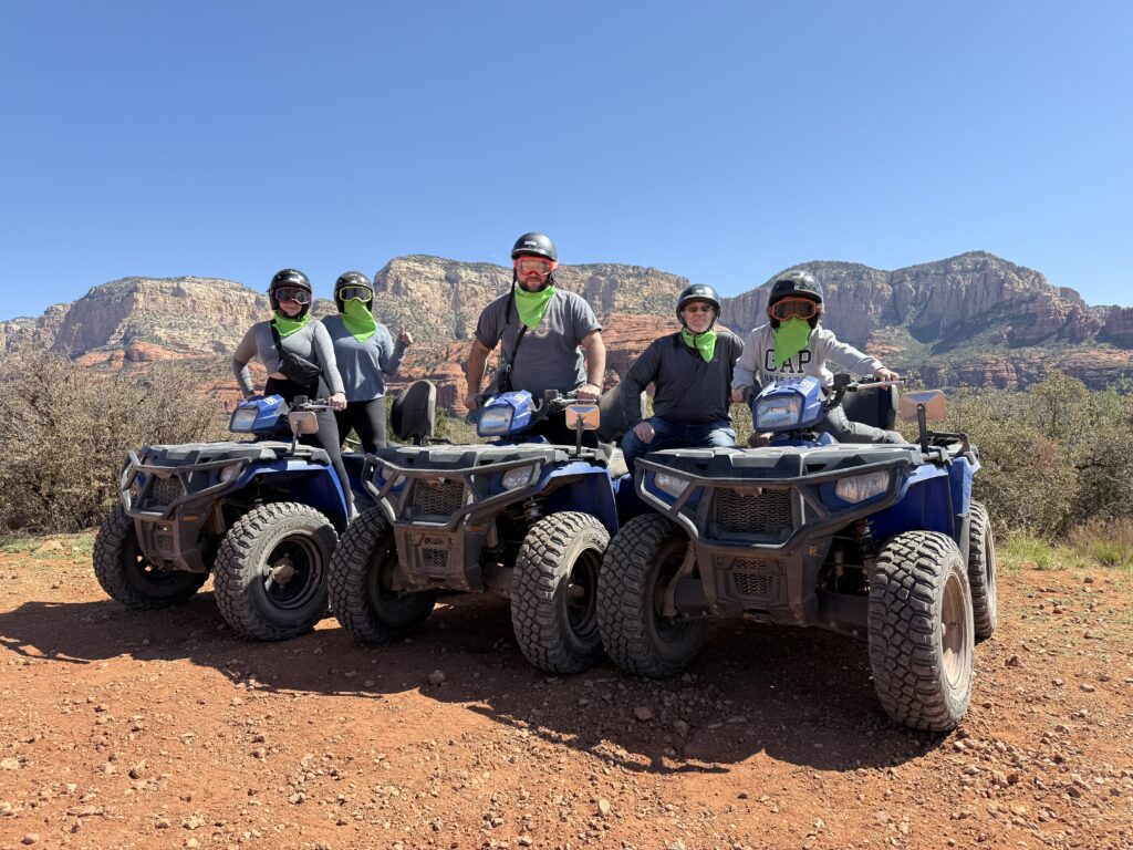 A group posing with their ATVs