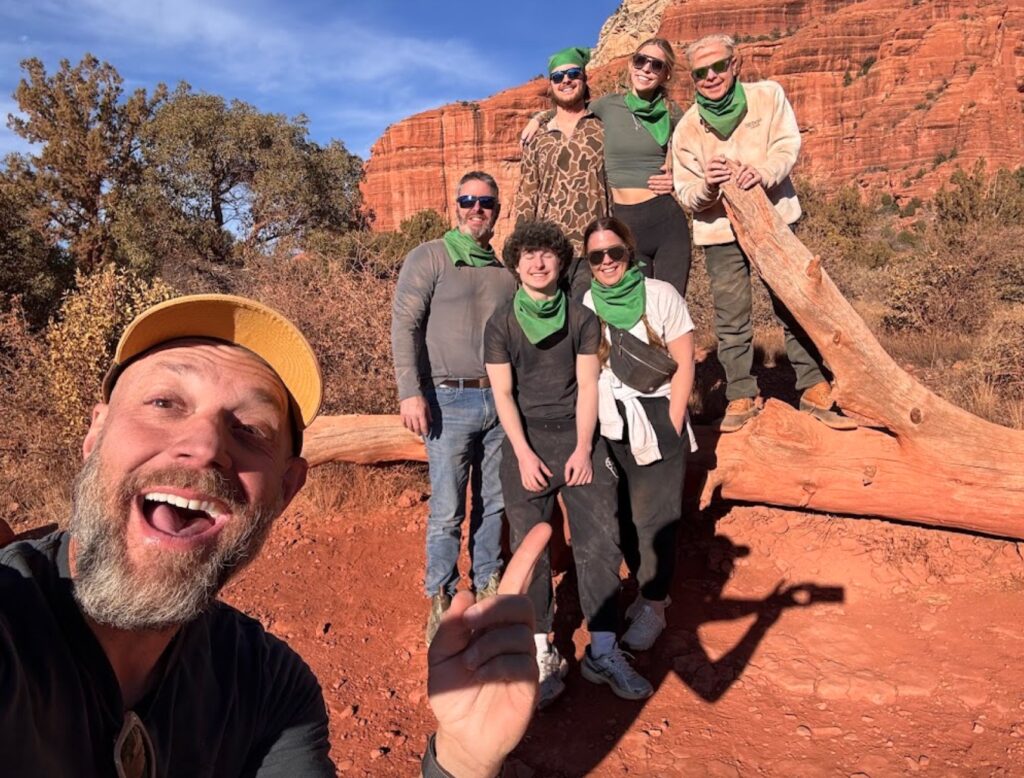 A group of people taking a selfie with guide during ATV tour
