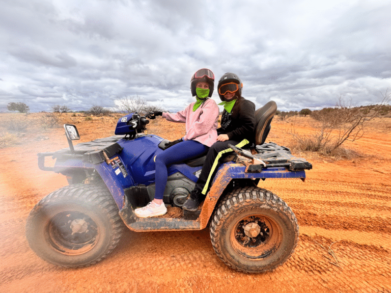 Riders on a Sedona ATV tour through red rock trails at sunset