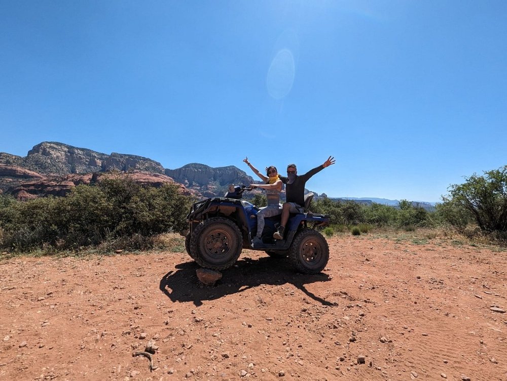 an ATV is parked on Sedona trail with mountains and vegetation in the background