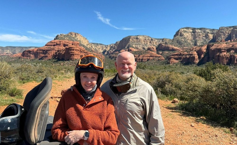 Vibrant red rock formations in Sedona, a rugged ATV driving on a dusty trail under a bright blue sky, cacti and desert vegetation surrounding the path, dramatic shadows and vibrant colors, capturing the spirit of adventure in the Arizona wilderness.